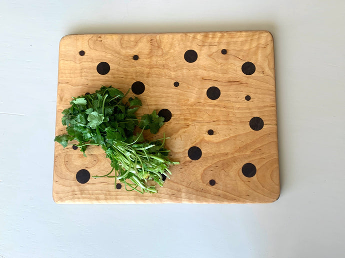 Large solid maple and walnut wood with dark polka dot cutting board that can be used as a serving platter and charcuterie board