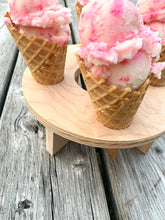 Large round ice cream cone holder serving strawberry ice cream waffle cones